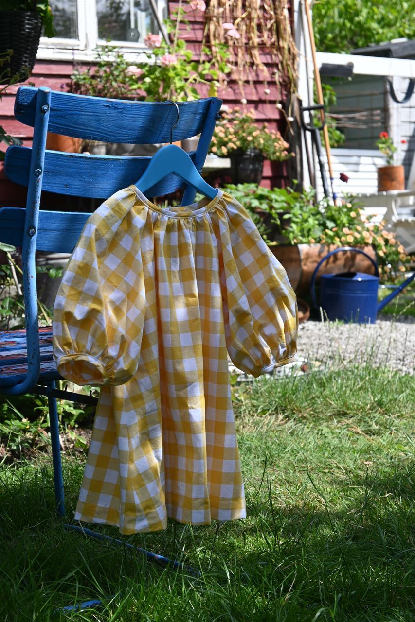 Barnklänning i bomullstyg Solruta