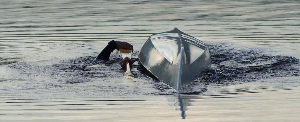 You lie upsidedown and face towards the right side of the kayak