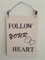 Skylt "Follow your heart"