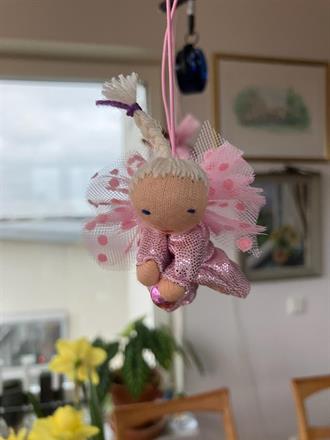 Liten ljusrosa skyddsängel med vit fläta