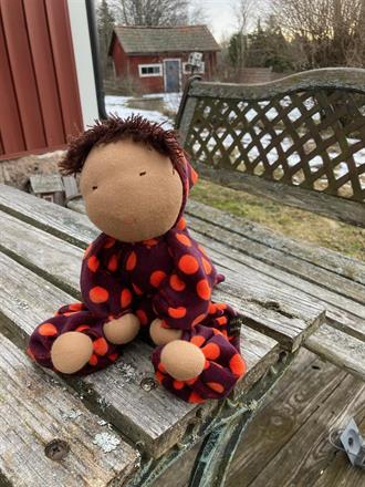 * Lila velour med orange stor prickar i dräkt och luva. 