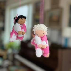 Doll mobile in pink ring with 4 dolls
