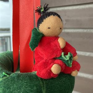 Christmas-inspired doll mobile with green ring