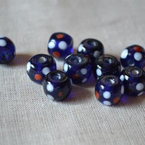 Blå pärla med röda och vita prickar